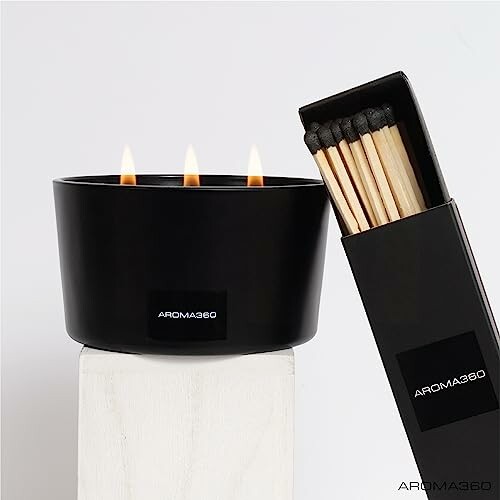 Black Aroma360 candle with three flames and box of matches.