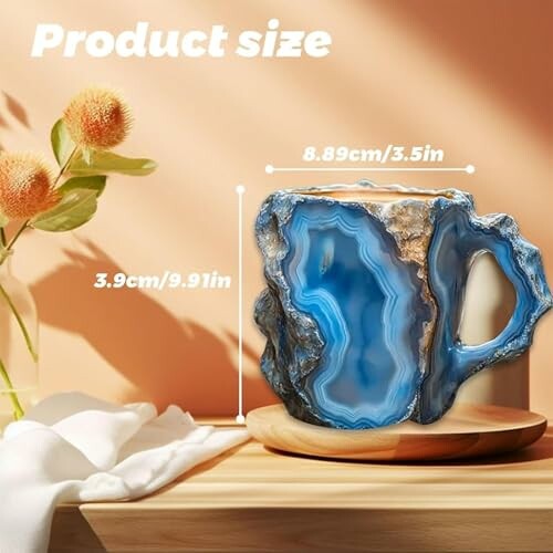 Blue geode mug with measurements on a wooden surface