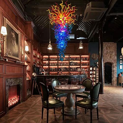 Luxurious bar with colorful chandelier, round table, and chairs.