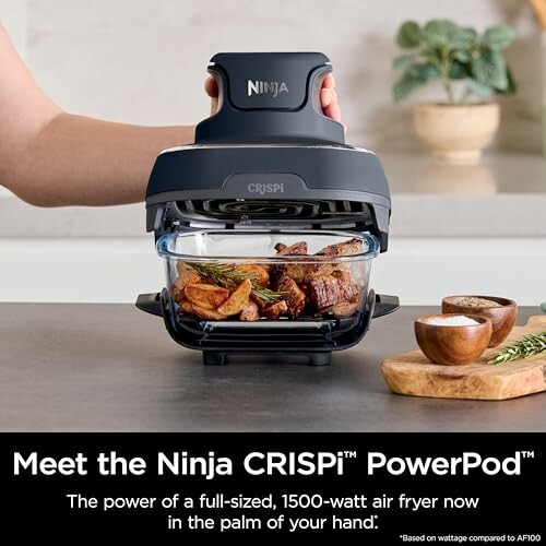 Ninja CRISPi PowerPod air fryer with cooked food inside.