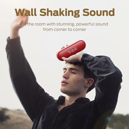 Person holding a red portable speaker, text 'Wall Shaking Sound'.