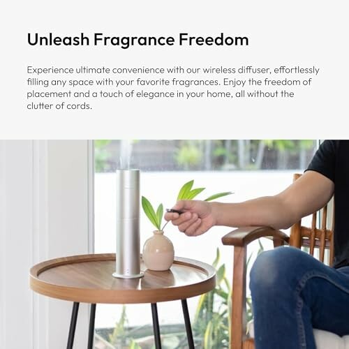 Person using a wireless diffuser on a table near a window.
